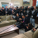 Here is the table being disrespected by a gaggle of press. Image via Getty.